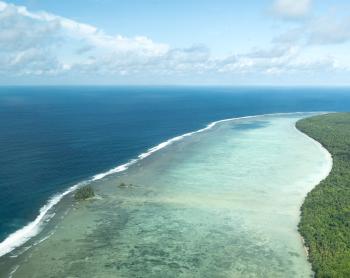 Ocean waves can be seen meeting the edge of Wuvulu.