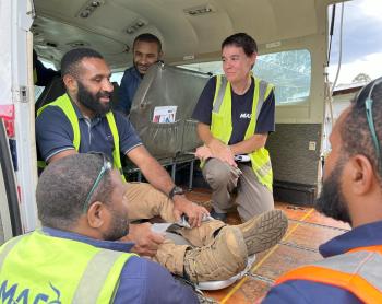 Bridget training a group of ground ops staff while in the MAF aircraft