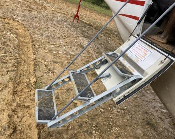 muddy airstrip, muddy stairs into the aircraft