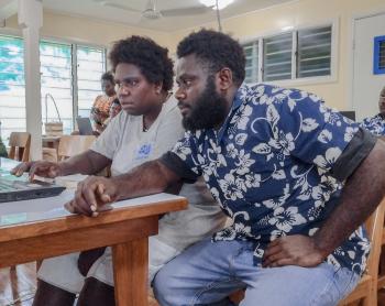 BCT Buka participants working hands-on with a computer during the training session.