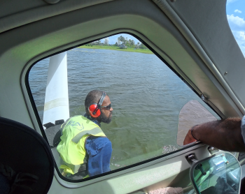 Titus Oaeke fastening the floatplane at docking station