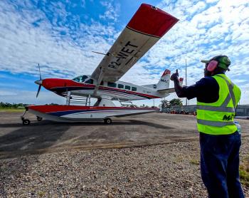Terry Lobog guiding taxiing plane