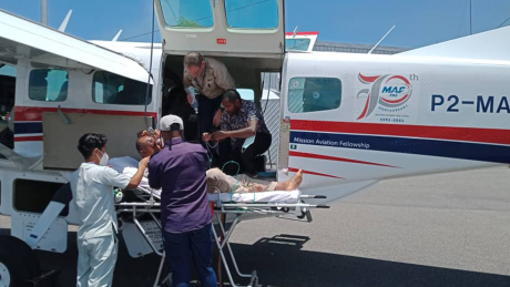 Medevac received in Port Moresby and patient getting transfered to ambulance stretcher