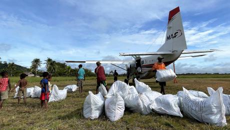 Unloading mosquito net bales at Edwaki