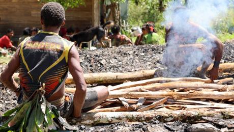 Yifki - people sitting at the mumu fire