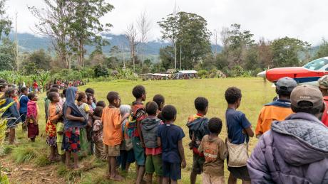 Villagers circle the runway upon the MAF plane's arrival.