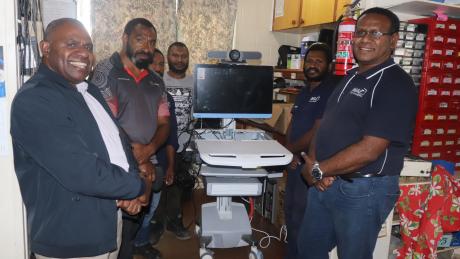 Simbu Provincial Heal Authority Team and MAF Technologies Team posing together with the Tele medicine equipment at MAF Tech workshop.