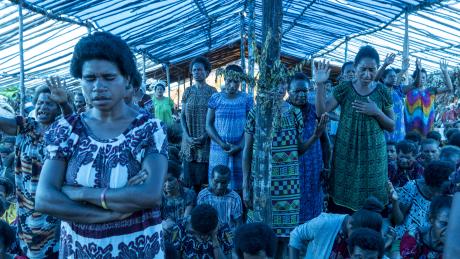 women under a tarpaulin tent worshipping God as part of the Min Baptist Union Women Conference at Eliptamin