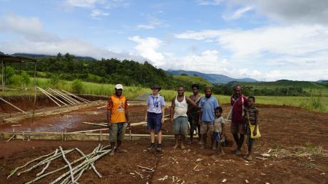 MAF Pilot Bridget Ingham with Mamusi missionary Andrew Gee, contractors, and Mamusi locals at the site of the new church.