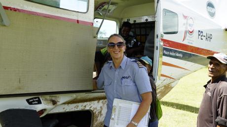 MAF Pilot Glenys Watson smiling beside MAF plane.