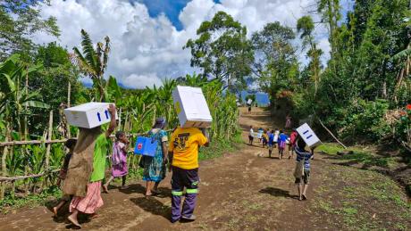 locals from remote Sindeni village carrying the mdical supplies to the health center