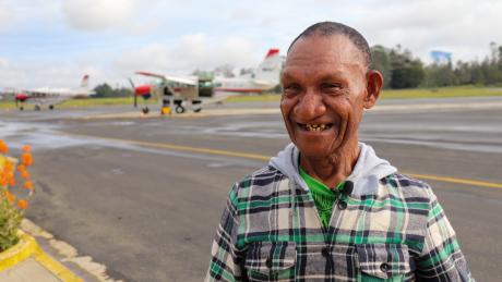 A man posing near an aircraft