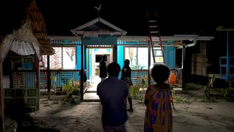 The successful installation of solar lighting at the clinic is revealed as the lights shine brightly at night