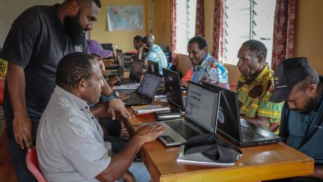 Kowara Bell offers guidance to a participant during basic computer training.