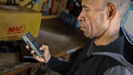 Isaac Yuma uses an HF radio to stay connected with his community, where mobile phone coverage is unavailable.