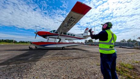 Terry Lobog guiding taxiing plane