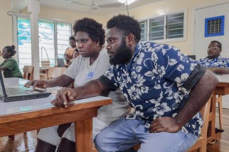 BCT Buka participants working hands-on with a computer during the training session.