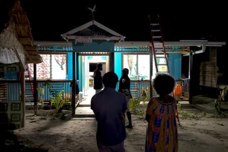 The successful installation of solar lighting at the clinic is revealed as the lights shine brightly at night