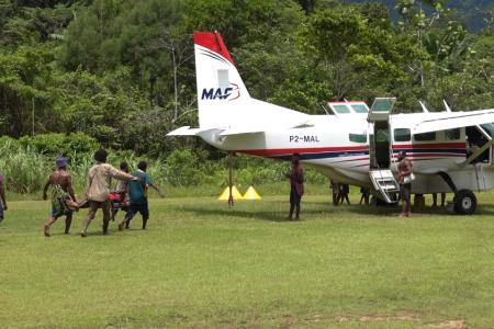 Kaiam Medevac patient being lifted unto MAF plane