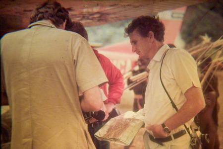A man looks at a map standing near a plane