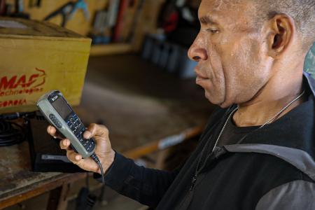 Isaac Yuma uses an HF radio to stay connected with his community, where mobile phone coverage is unavailable.