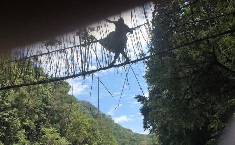 Crossing the vine bridge across the Sepik River and carrying a heavy bag 