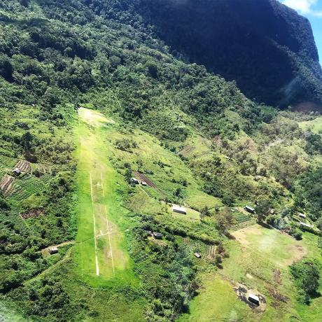 Wetap airstrip surrounded by a few houses and gardens