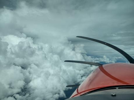 a pilots view: lots of cloud formations but still with reference to the ground