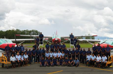 ground operations team November 2024 posing in front of 3 aircraft