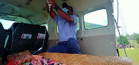 Joseph Tua attaching the IV bag at the cabin ceiling