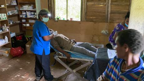 Dr Camy Thomas with a patient at the Maulamanda health post