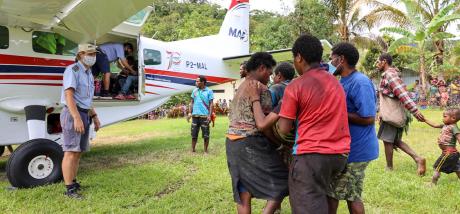 Yifki medevac - Friends assisting the patient to be brought to the aircraft