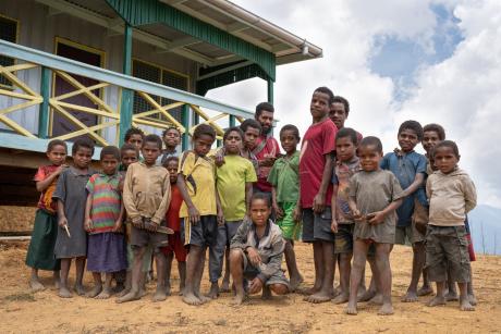 Dusin villagers pose for photo outside Nazarene Health Services health center.