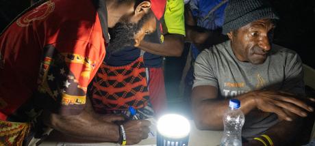 A man signing the Senisim Pasin Pledge at Pyarulama