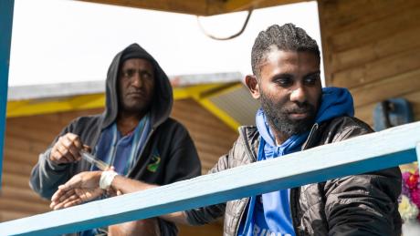 Wesley Jeffry treats RMO and team leader Paias Korus with medication to fight malaria.