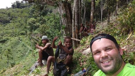 Terry takes a break with some villagers that are guiding him to Dimanbil.