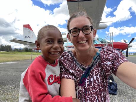 Grace and MAF's Communications Officer Mandy Glass after landing at Mt Hagen, with the MAF caravan in the background