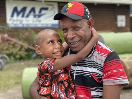 Mr Imit and his six year old daughter Grace at the Telefomin MAF base