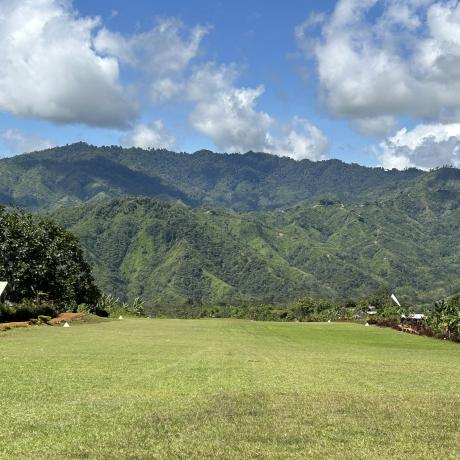 view down the airstrip against raising terrain 