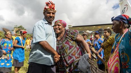 Representatives from the Min Baptist Union welcoming women arriving on the MAF plane