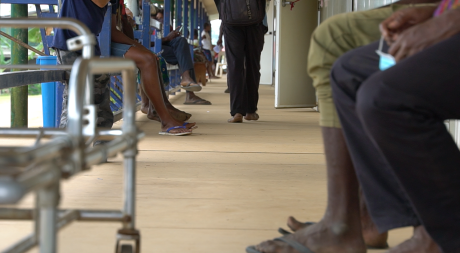 Patients waiting to be seen by a nurse. Only their feet are visible