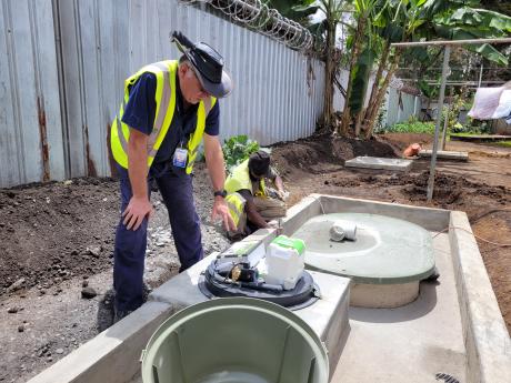 Dave Moore displaying new sewage system.