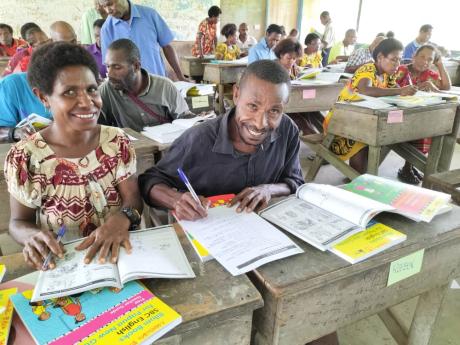 Two teachers participating in Bilum Books training course smiling at the camera.