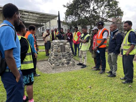 grade 12 students assembled around the MAF memorial honouring those pilots who lost their lives