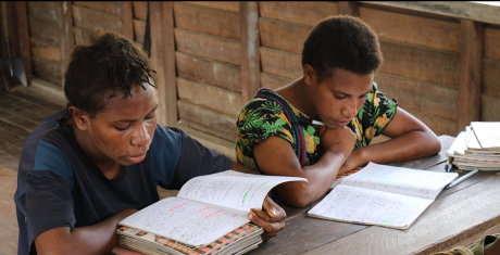 Students reading text book at the Wanakipa Primary Schoo