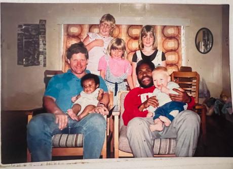 Photo taken in 1989. A young Marcus Grey is sitting with a 3-month old Esther Dii in his lap