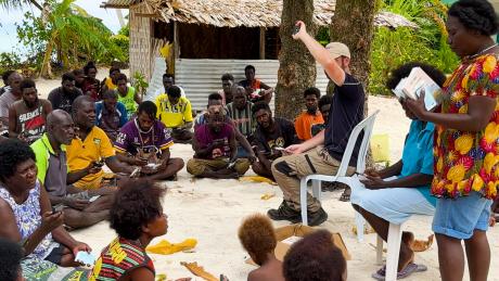 MAF Technologies team distributing printed and audio Bibles to locals on Han Island