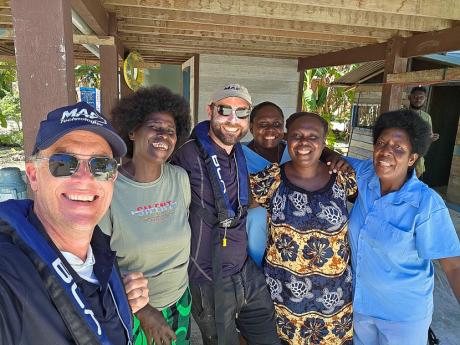 Nick Hitchins and Karlos Sarunic pose for a group photo with Han Clinic health workers. From left: Nick Hitchins (MAF), Bernice Kumis, Karlos Sarunic (MAF) and three nursing officers from Han Clinic.