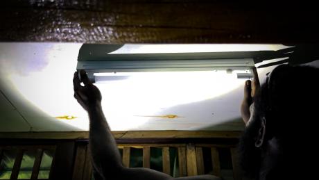 MAF technician installing a solar lights at the remote Han clinic on the island.