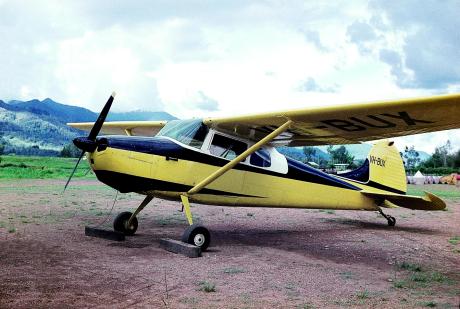 A plane on a dusty airstrip